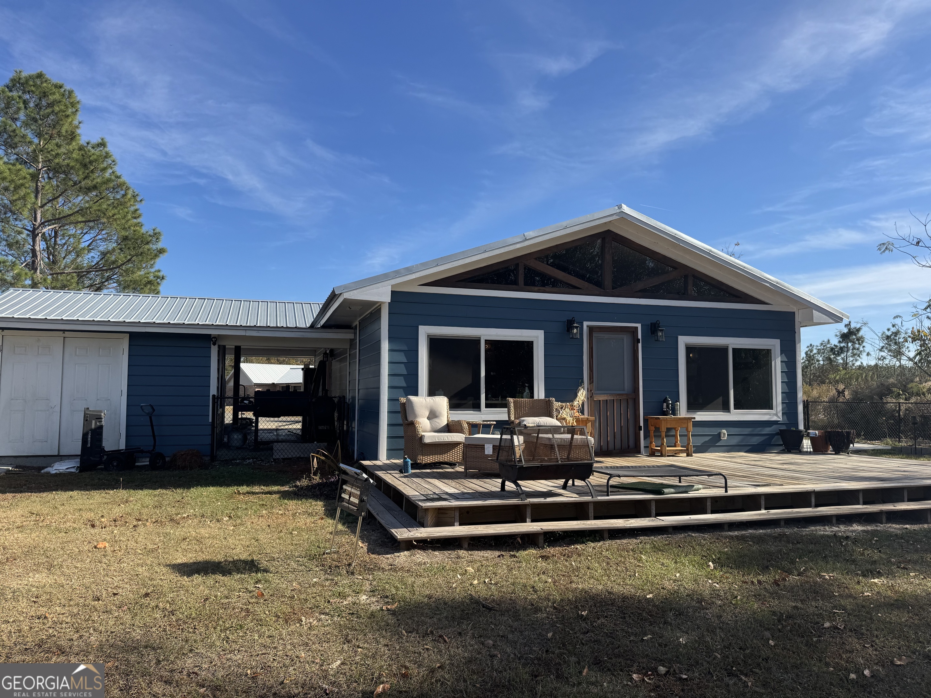 2648 Buck Head Road Baxley, GA 31513 - Photo 4 of 20 a front view of a house with swimming pool and furniture