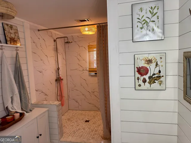 a bathroom with a shower and a sink