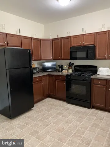 a kitchen with a refrigerator and a sink