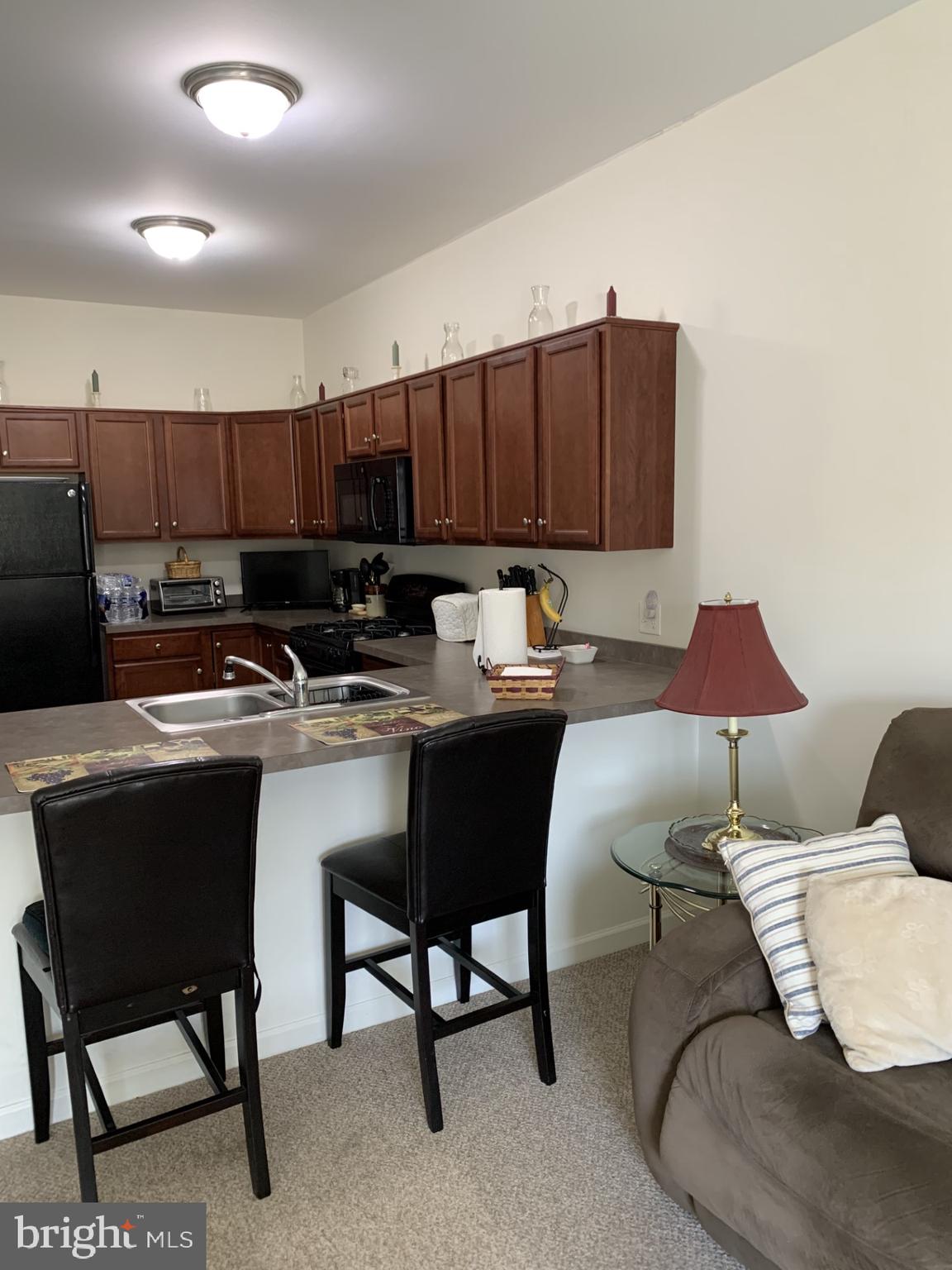 79 Legacy Boulevard, Unit 306 Sinking Spring, PA 19608 - Photo 5 of 11 a kitchen with a sink and cabinets