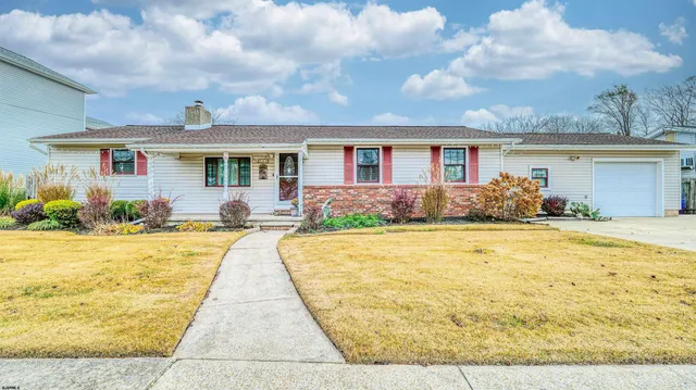 a front view of house with yard and outdoor seating