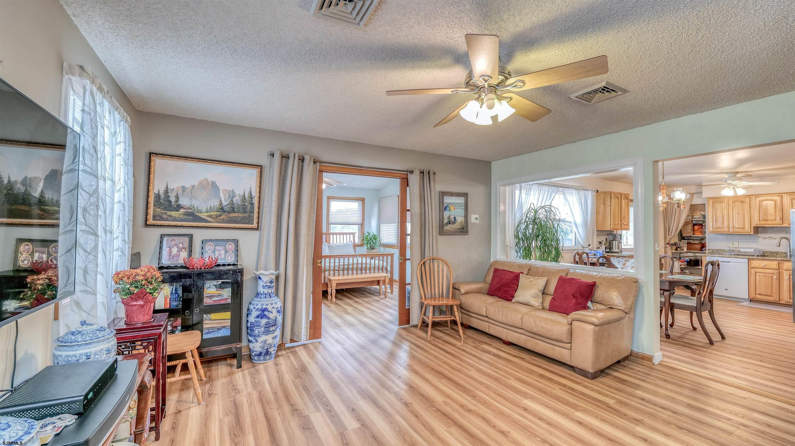 715 Lafayette Boulevard Brigantine, NJ 08203 - Photo 11 of 31 a living room with furniture and a large window