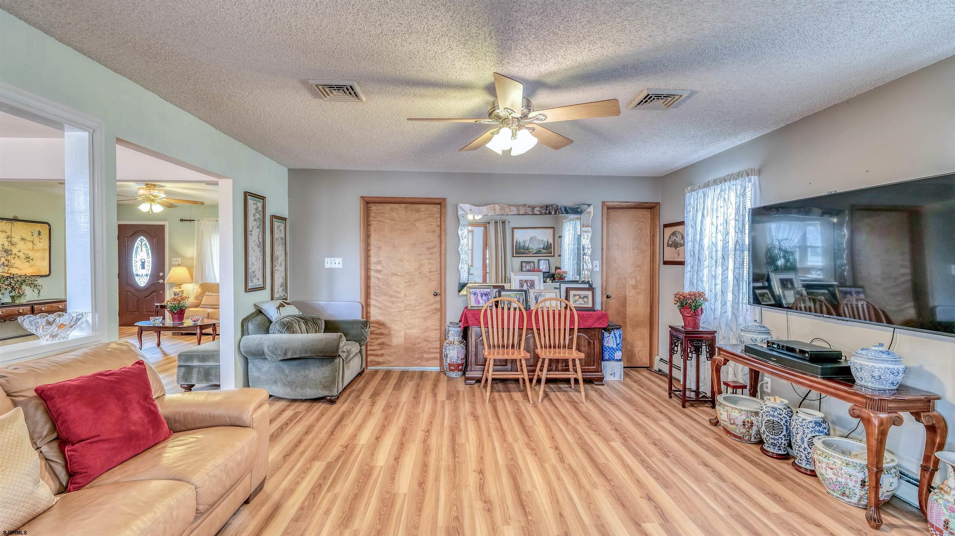 715 Lafayette Boulevard Brigantine, NJ 08203 - Photo 12 of 31 a living room with furniture and a flat screen tv