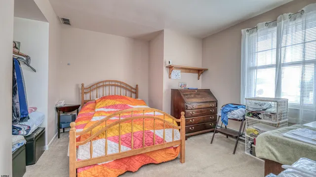 a bedroom with bed and a window