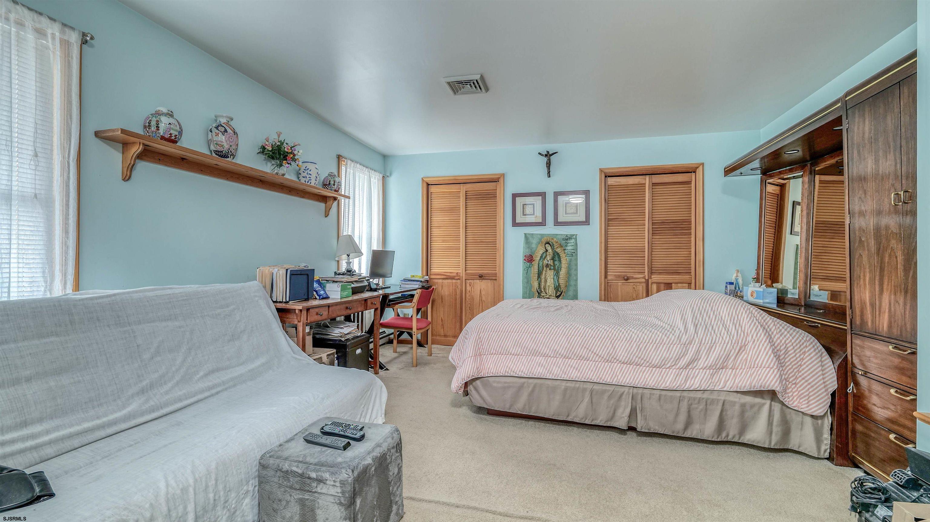 715 Lafayette Boulevard Brigantine, NJ 08203 - Photo 18 of 31 a bedroom with a bed and wooden floor