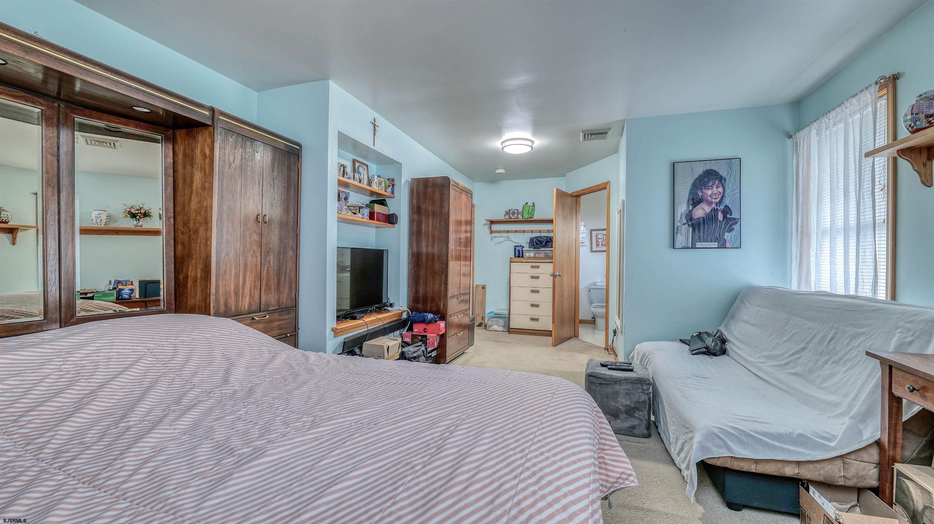 715 Lafayette Boulevard Brigantine, NJ 08203 - Photo 19 of 31 a bedroom with a bed and a large mirror
