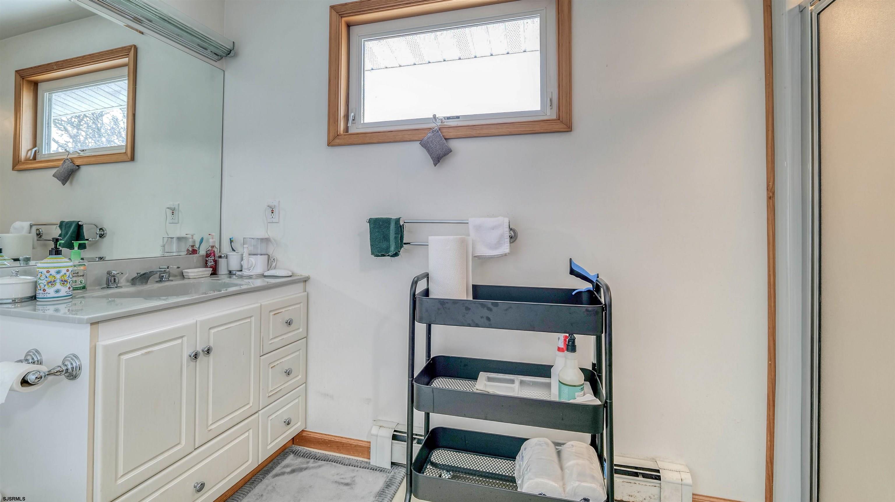 715 Lafayette Boulevard Brigantine, NJ 08203 - Photo 21 of 31 a bathroom with a toilet sink and a mirror