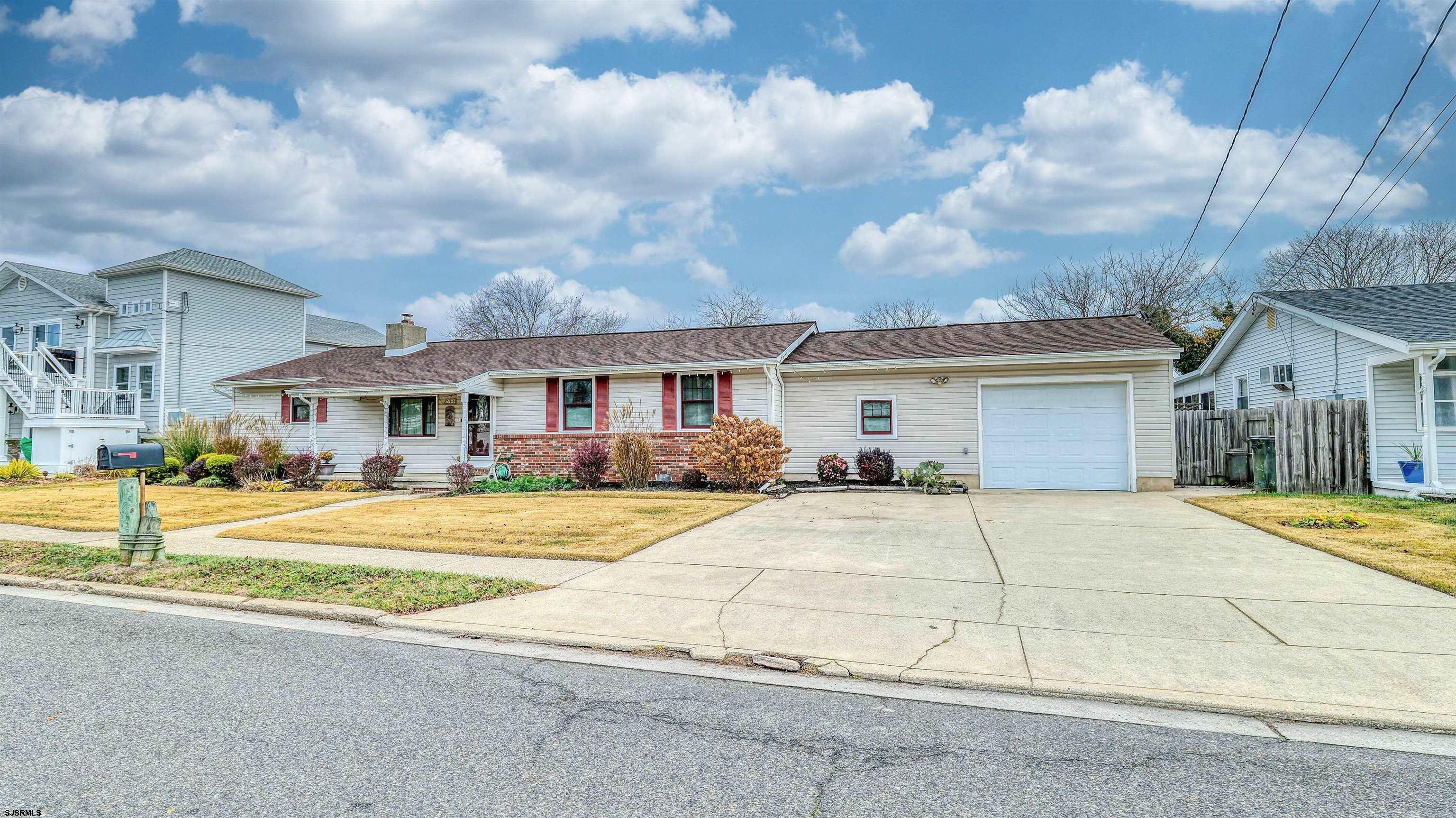 715 Lafayette Boulevard Brigantine, NJ 08203 - Photo 31 of 31 a front view of a house with a yard and garage