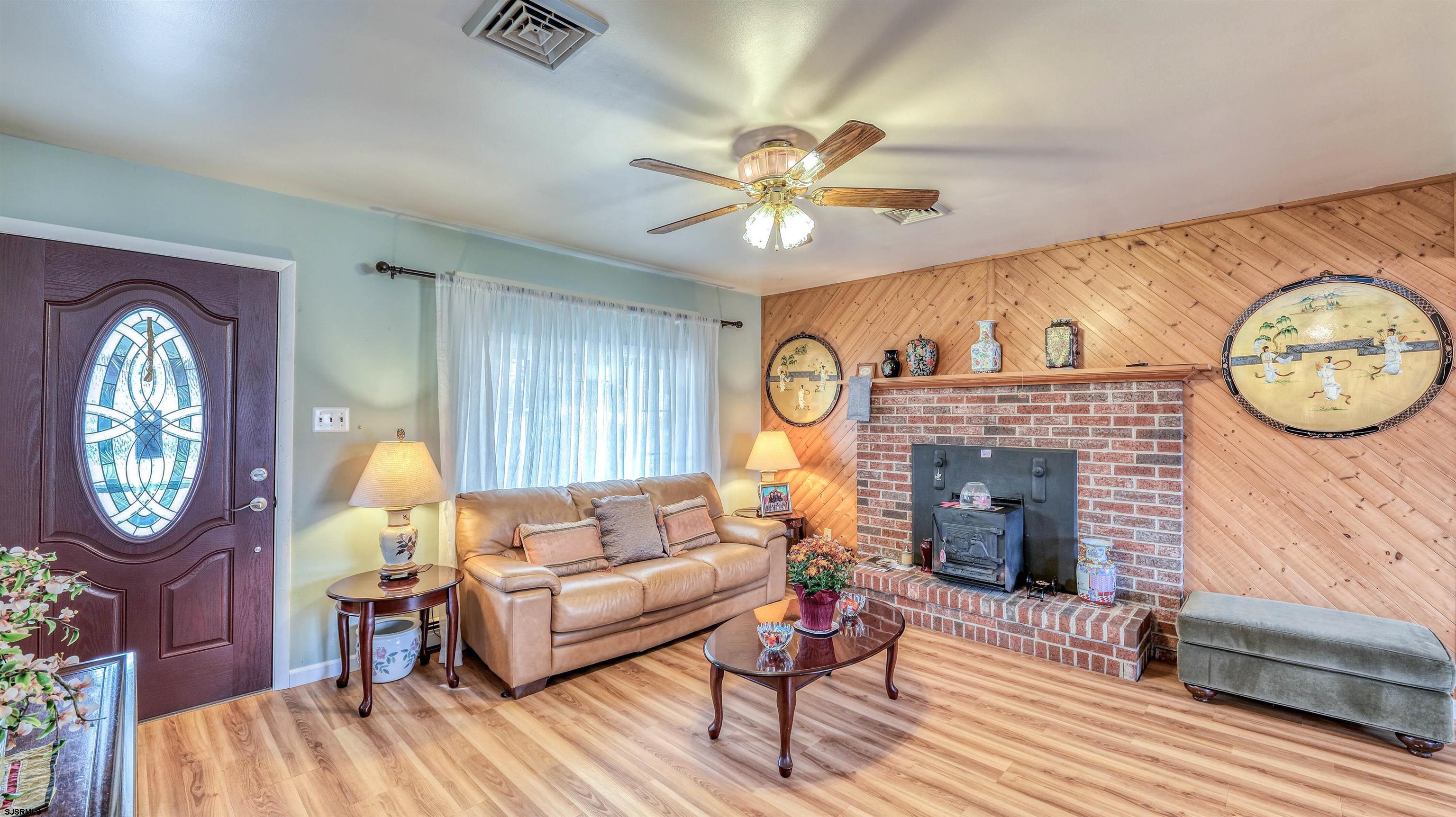715 Lafayette Boulevard Brigantine, NJ 08203 - Photo 4 of 31 a living room with furniture a clock and a window