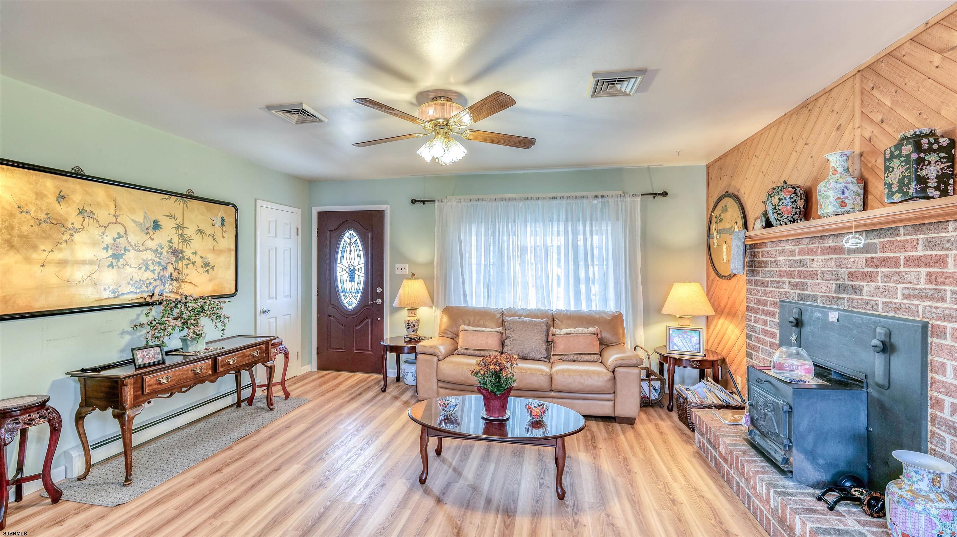 715 Lafayette Boulevard Brigantine, NJ 08203 - Photo 5 of 31 a living room with furniture and a fireplace