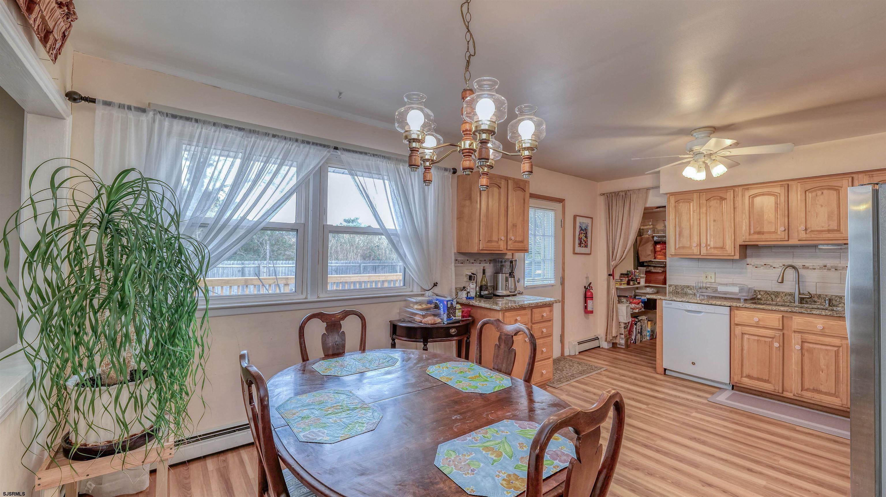 715 Lafayette Boulevard Brigantine, NJ 08203 - Photo 7 of 31 a view of a dining room with furniture window and wooden floor
