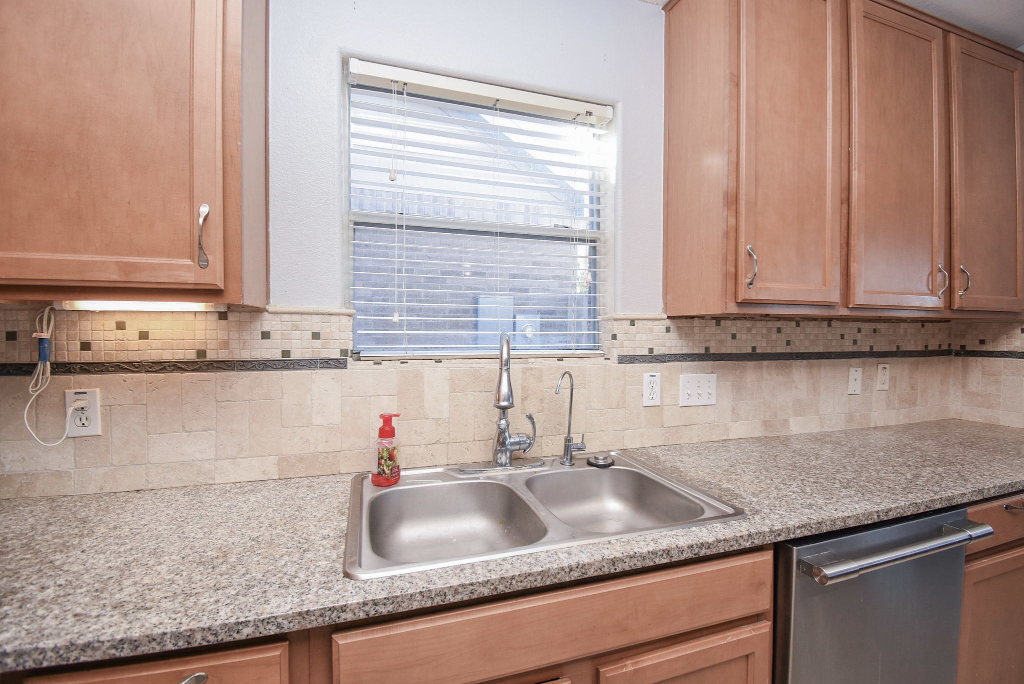 8502 Parapet Place Rosharon, TX 77583 - Photo 13 of 34 a kitchen with granite countertop a sink and a window
