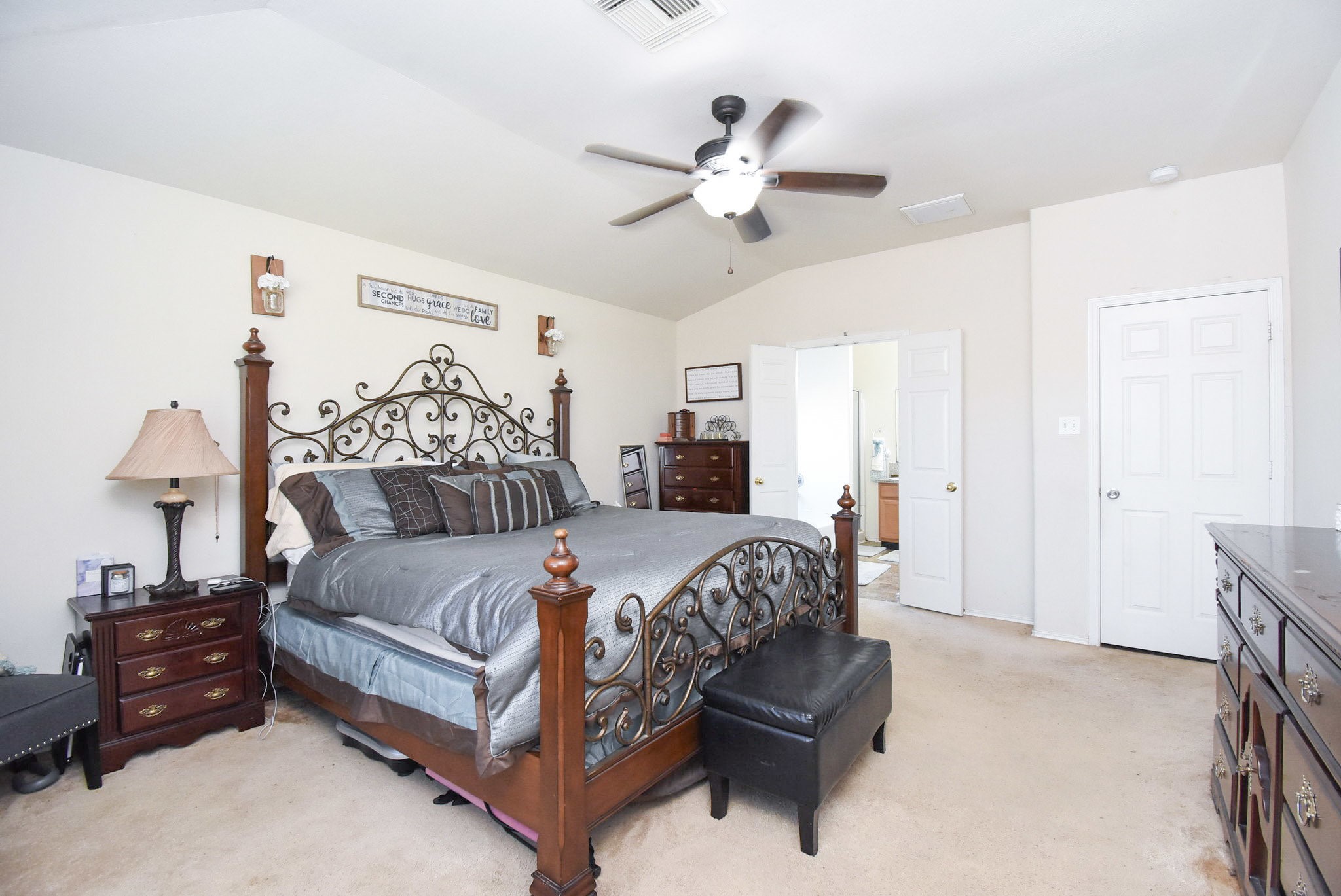 8502 Parapet Place Rosharon, TX 77583 - Photo 18 of 34 a bedroom with a bed and a chandelier