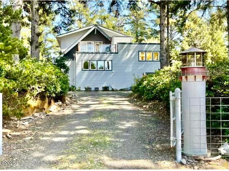 a view of a street with potted plants and large trees
