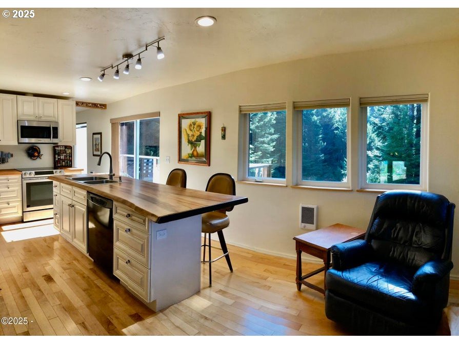 3512 Highway 101 Yachats, OR 97498 - Photo 11 of 39 a living room with furniture a flat screen tv and a window