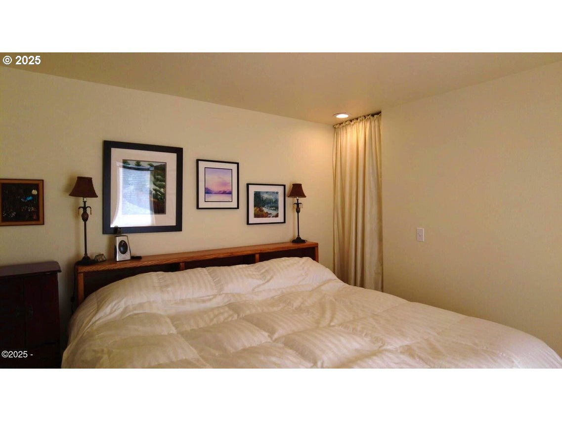 3512 Highway 101 Yachats, OR 97498 - Photo 14 of 39 a room with a bed and a painting on the wall