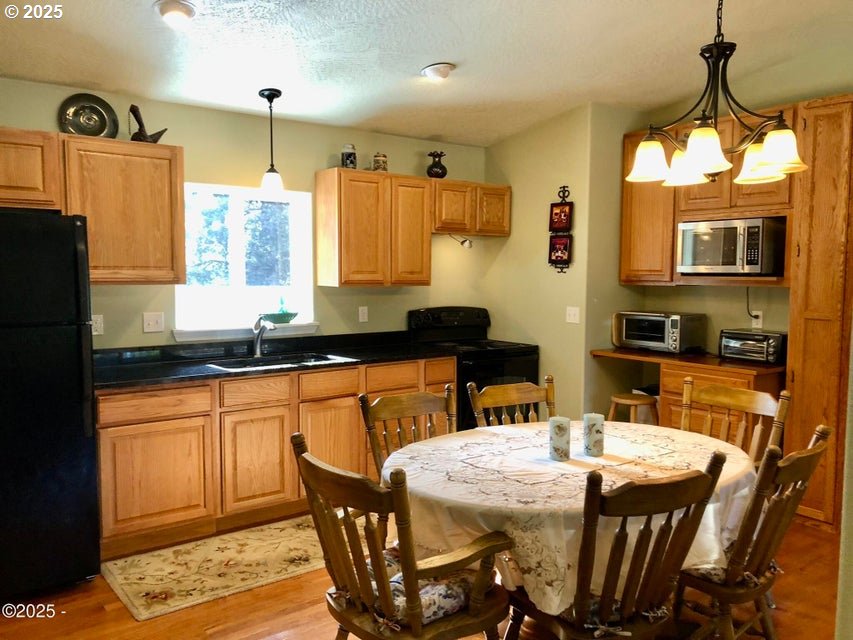 3512 Highway 101 Yachats, OR 97498 - Photo 21 of 39 a kitchen with stainless steel appliances granite countertop a sink a stove a refrigerator and island
