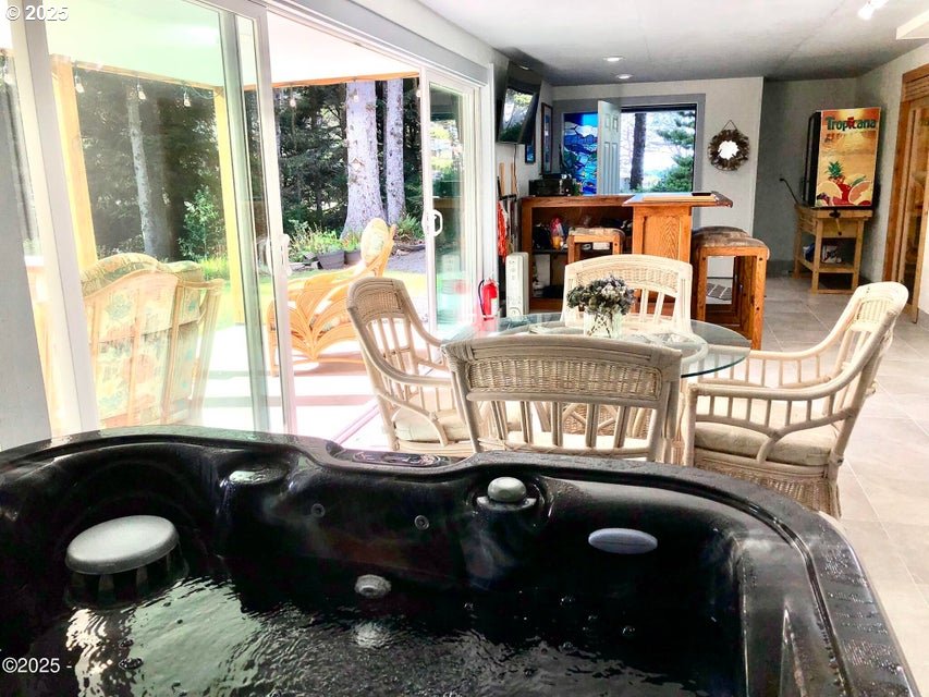 3512 Highway 101 Yachats, OR 97498 - Photo 6 of 39 a living room with furniture and a floor to ceiling window