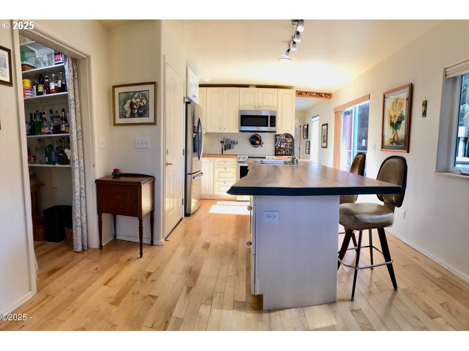 3512 Highway 101 Yachats, OR 97498 - Photo 10 of 39 a view of a kitchen with furniture and wooden floor