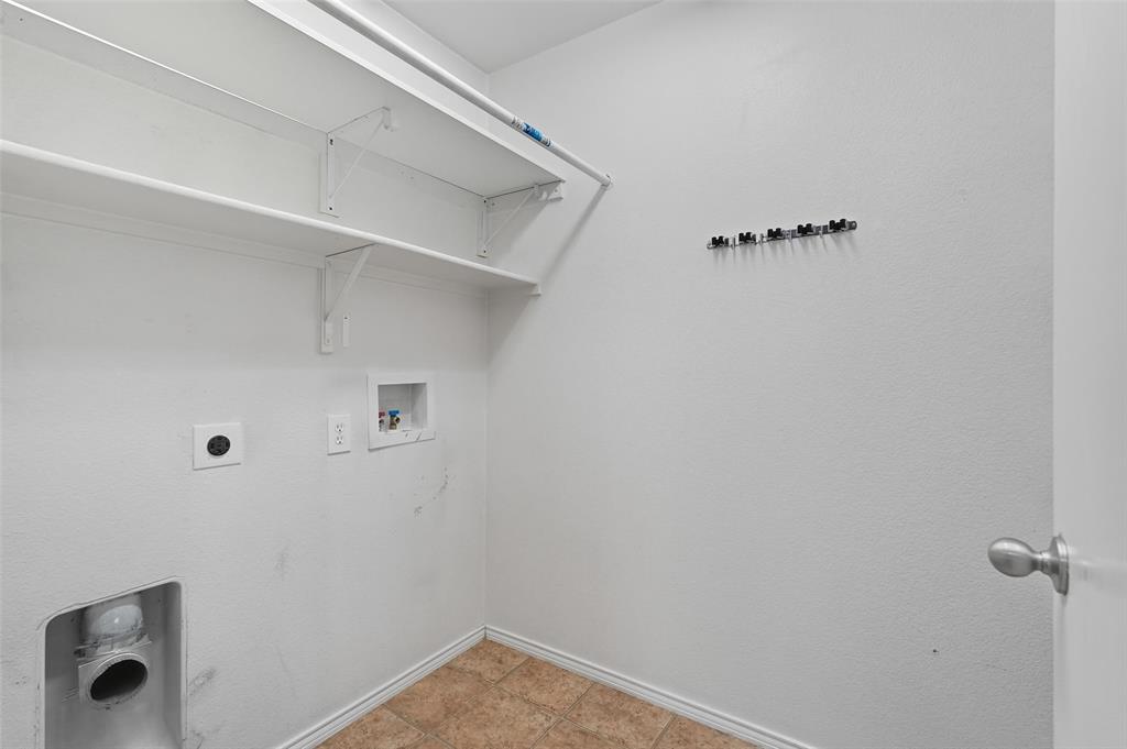 322 Laurel Lane Fate, TX 75087 - Photo 12 of 22 a view of small space with racks on the wall