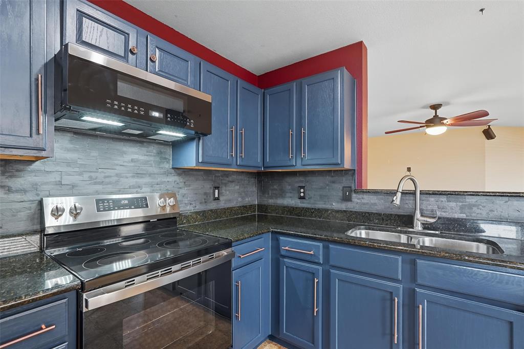 322 Laurel Lane Fate, TX 75087 - Photo 16 of 22 a kitchen with stainless steel appliances granite countertop a sink and cabinets