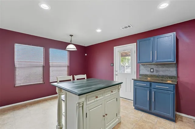 a kitchen with a stove a sink dishwasher and a refrigerator with wooden floor