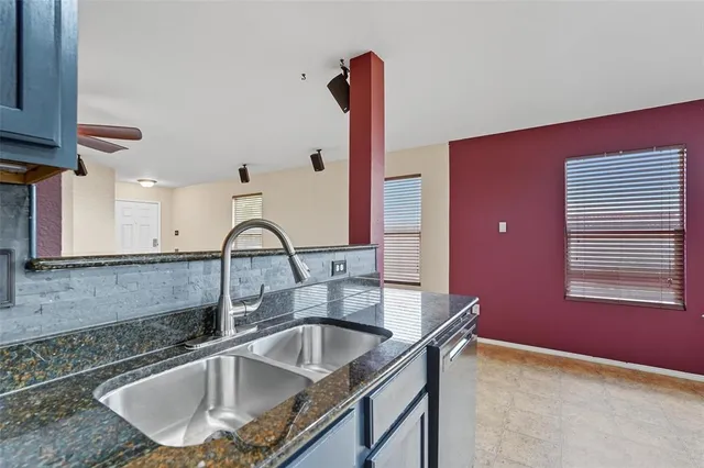 a kitchen with a sink cabinets and a window