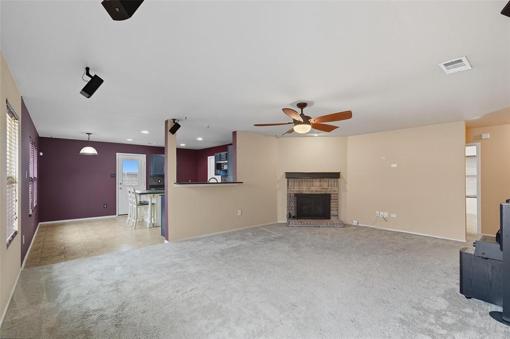 322 Laurel Lane Fate, TX 75087 - Photo 3 of 22 a view of a livingroom with a ceiling fan fireplace and window
