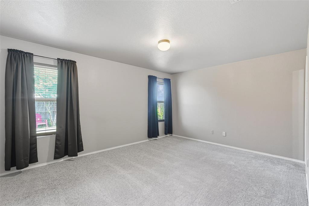 322 Laurel Lane Fate, TX 75087 - Photo 6 of 22 a view of an empty room with wooden floor and windows