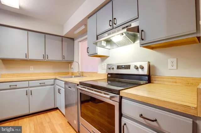 a kitchen with stainless steel appliances granite countertop a sink and cabinets