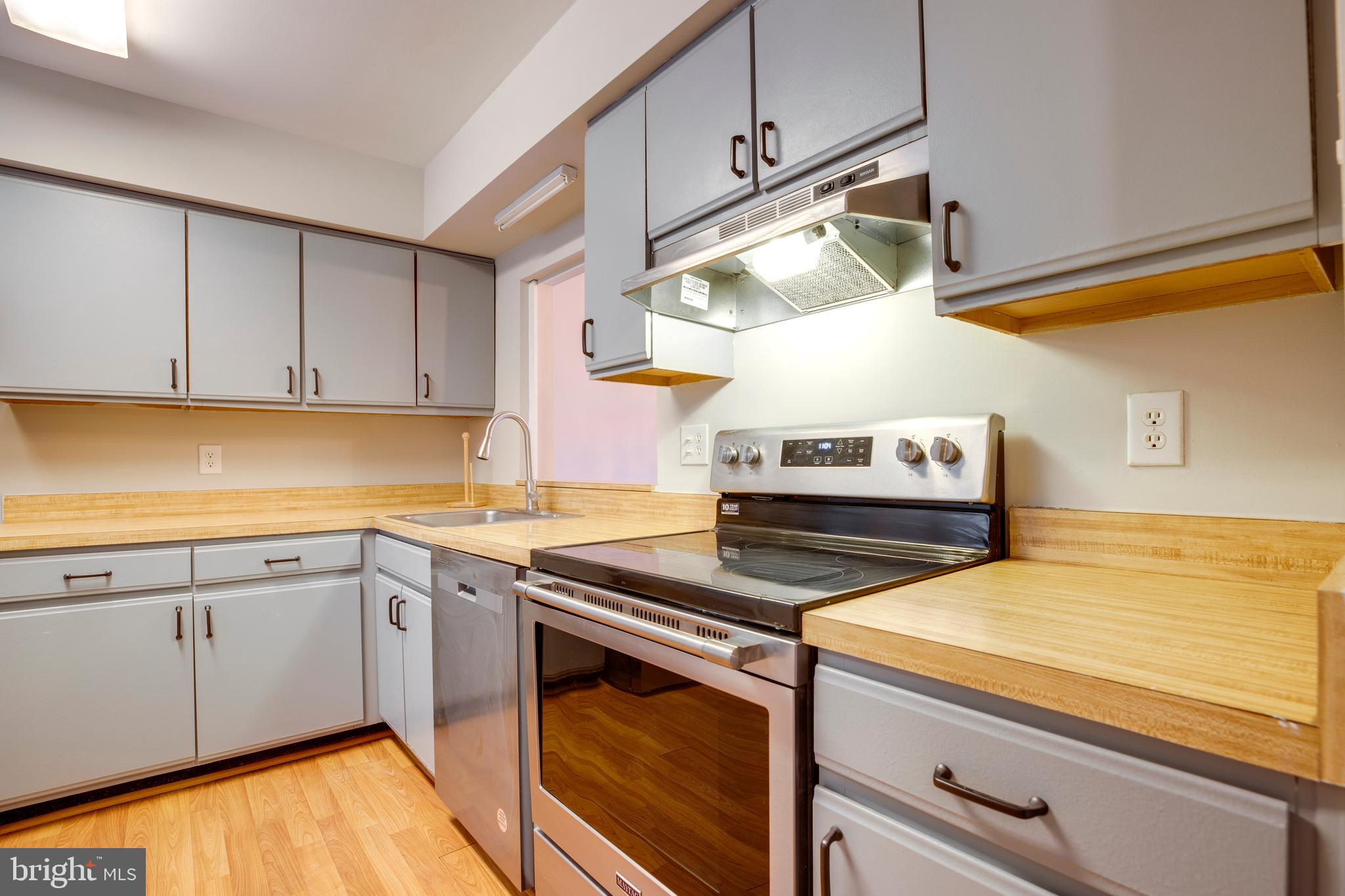 241 Coventry Square Sterling, VA 20164 - Photo 12 of 29 a kitchen with stainless steel appliances granite countertop a sink and cabinets