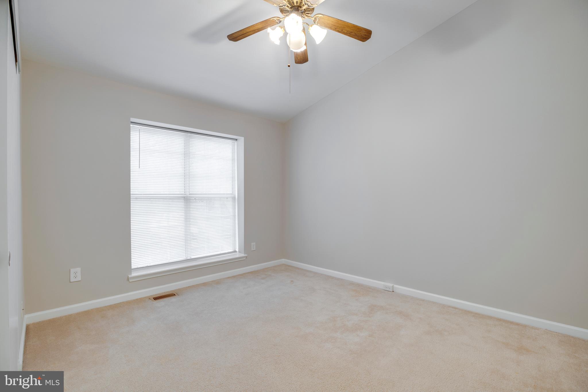 241 Coventry Square Sterling, VA 20164 - Photo 15 of 29 an empty room with a chandelier fan and windows