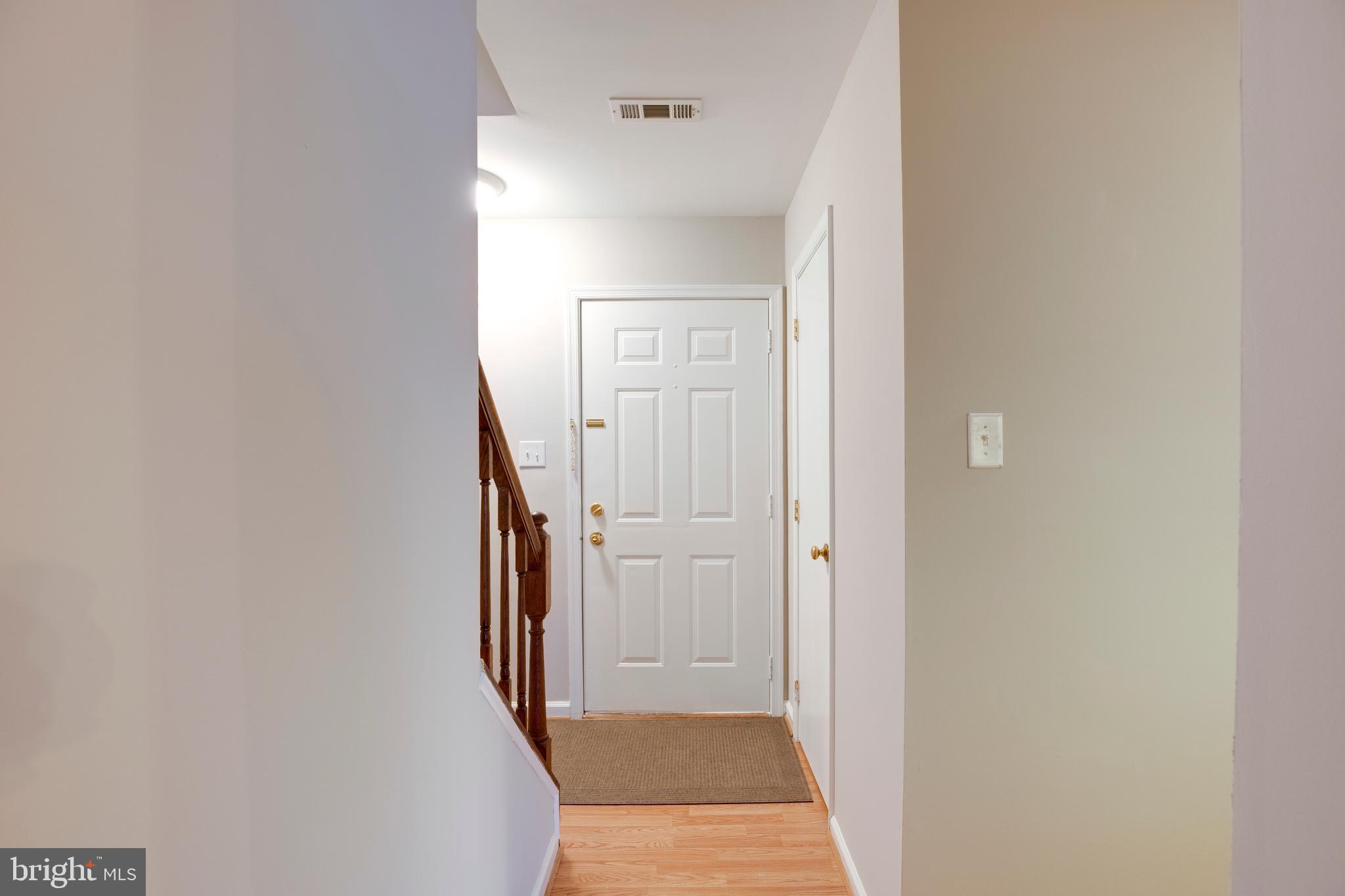 241 Coventry Square Sterling, VA 20164 - Photo 20 of 29 a view of a hallway with wooden floor and entryway