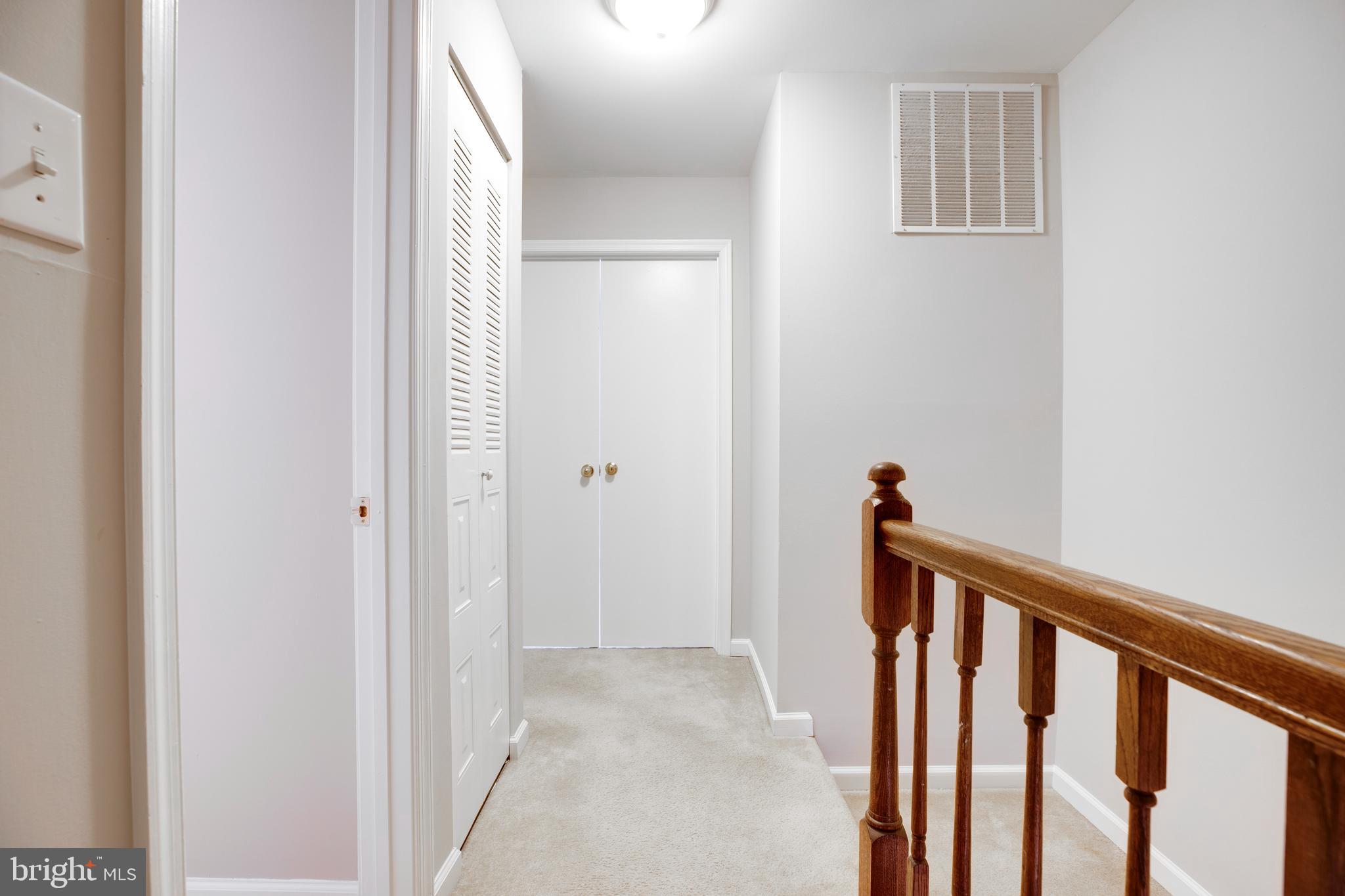 241 Coventry Square Sterling, VA 20164 - Photo 24 of 29 a view of a hallway with a white door and stairs