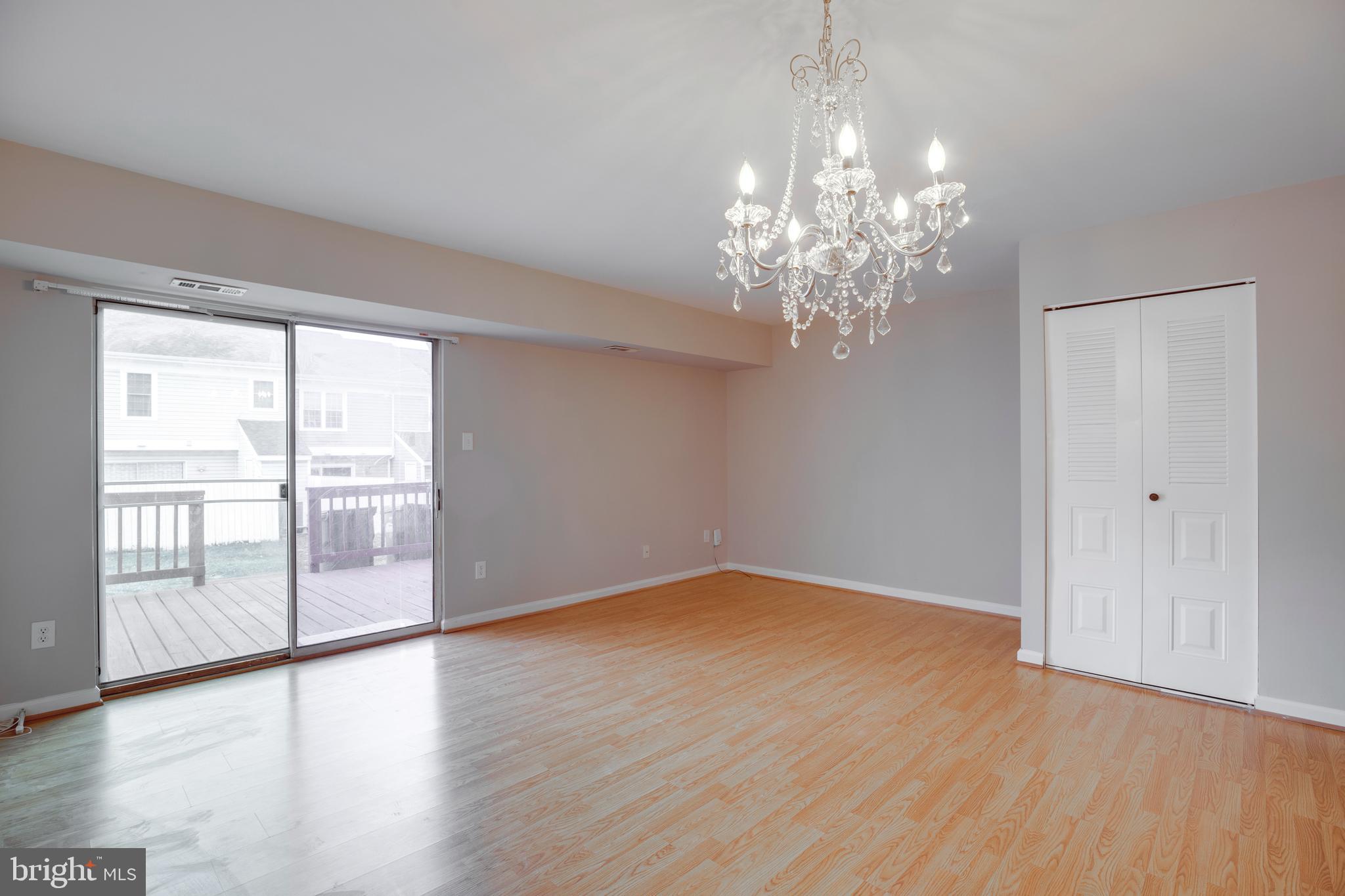 241 Coventry Square Sterling, VA 20164 - Photo 4 of 29 a view of an empty room with wooden floor and a window