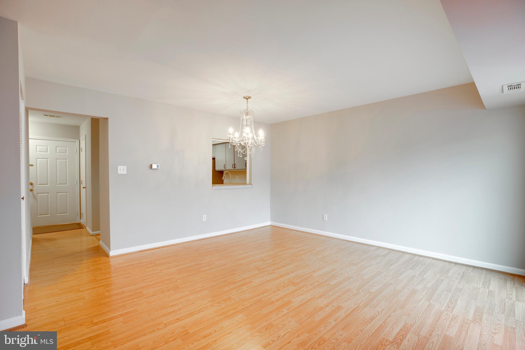 241 Coventry Square Sterling, VA 20164 - Photo 7 of 29 an empty room with wooden floor and windows