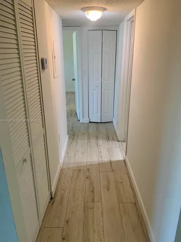 a kitchen with a stove top oven and cabinets