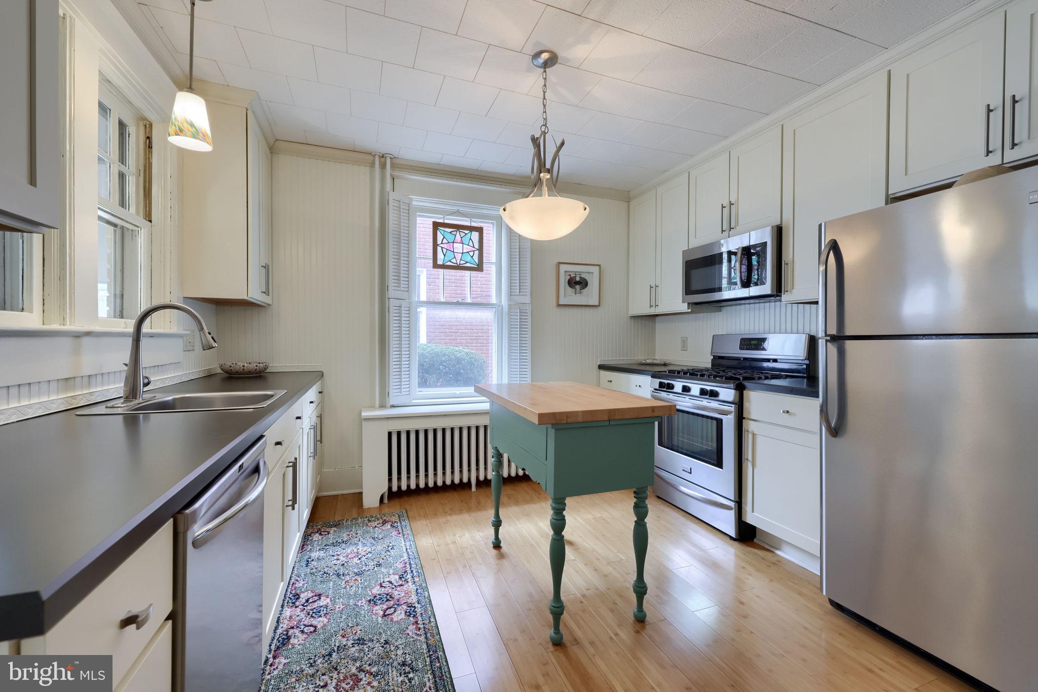 1013 Locust Street Columbia, PA 17512 - Photo 22 of 47 a kitchen with stainless steel appliances granite countertop a sink stove and refrigerator