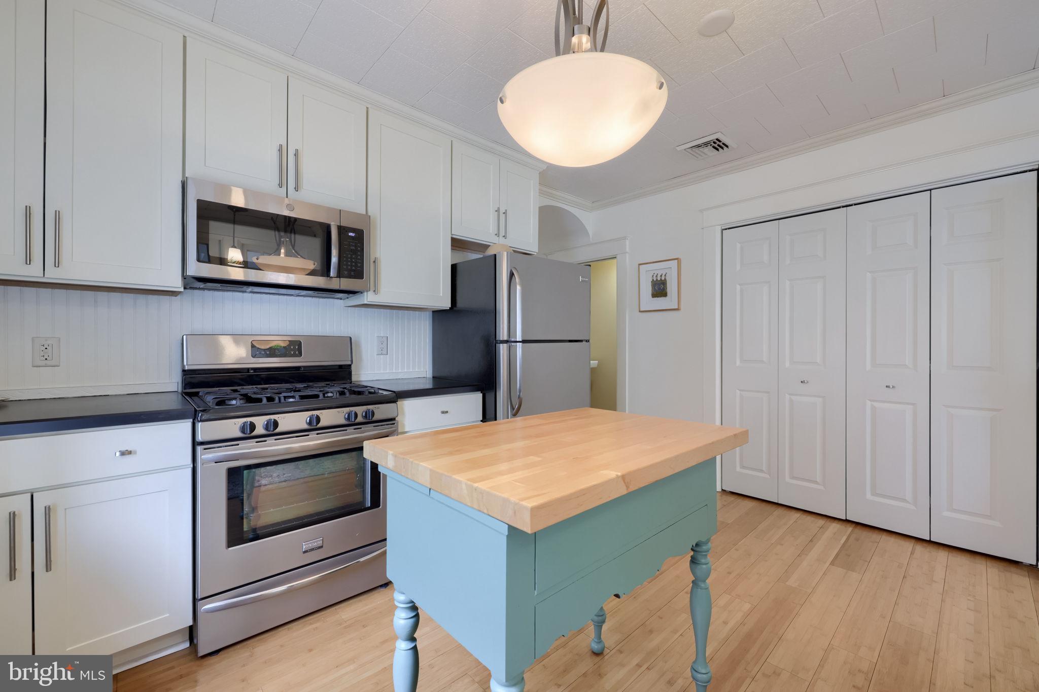 1013 Locust Street Columbia, PA 17512 - Photo 25 of 47 a kitchen with stainless steel appliances granite countertop a stove a refrigerator and a microwave