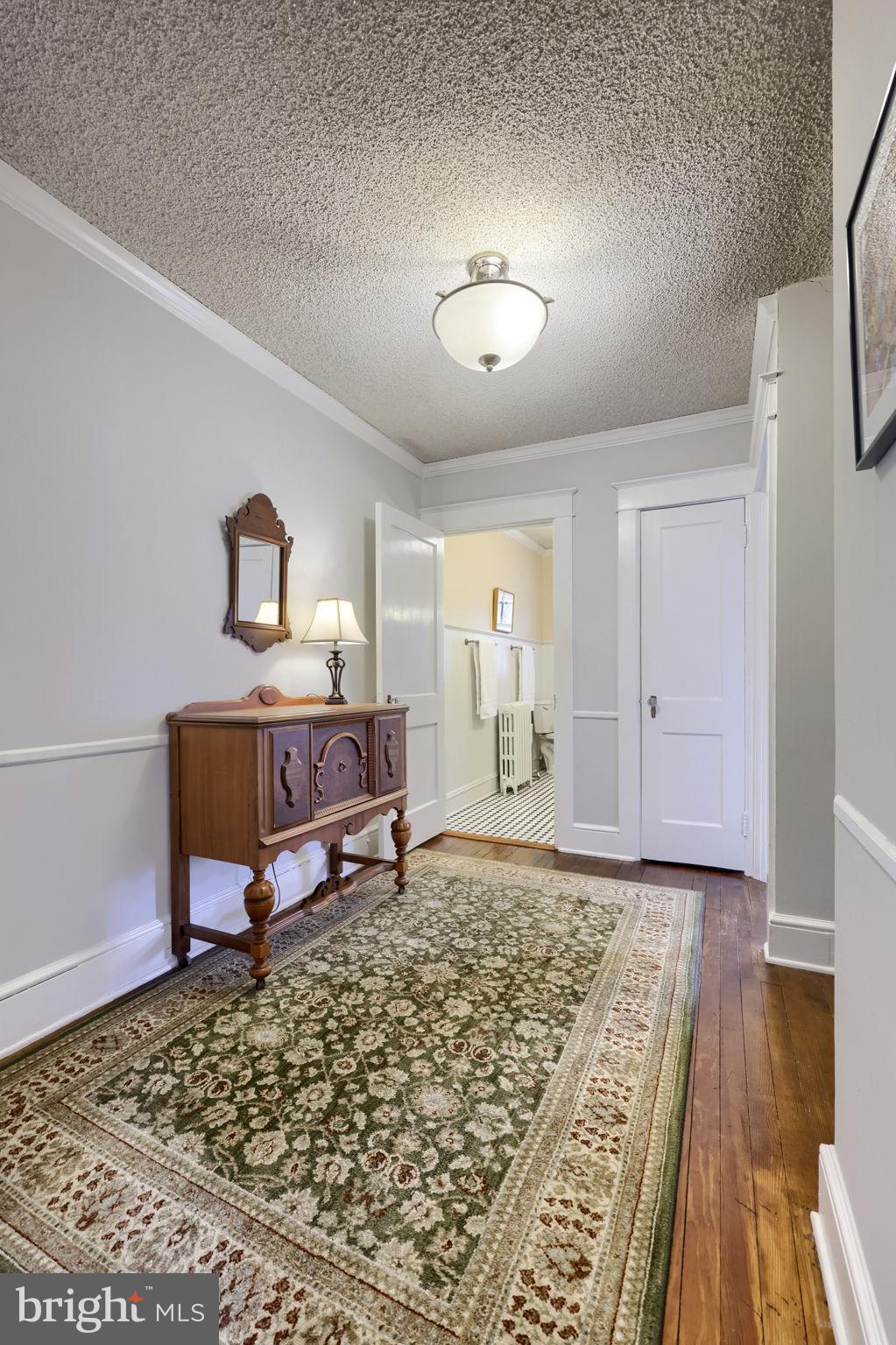 1013 Locust Street Columbia, PA 17512 - Photo 32 of 47 a bedroom with a bed and wooden floor