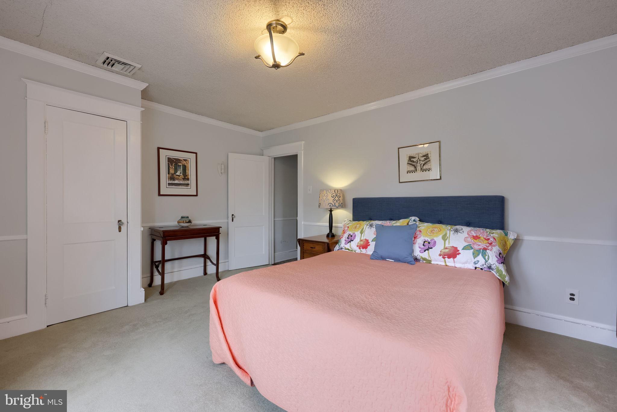 1013 Locust Street Columbia, PA 17512 - Photo 34 of 47 a bedroom with a bed and a chandelier