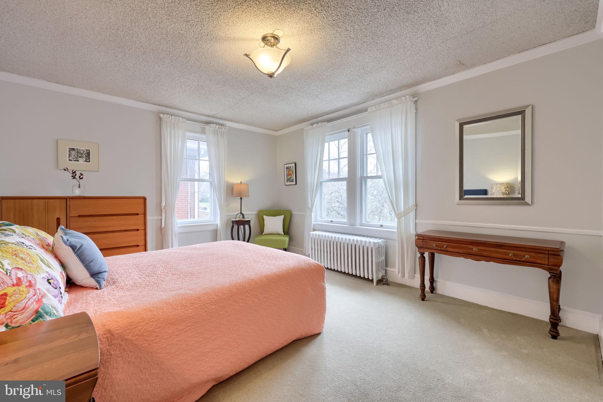 1013 Locust Street Columbia, PA 17512 - Photo 35 of 47 a bedroom with a bed and a chandelier