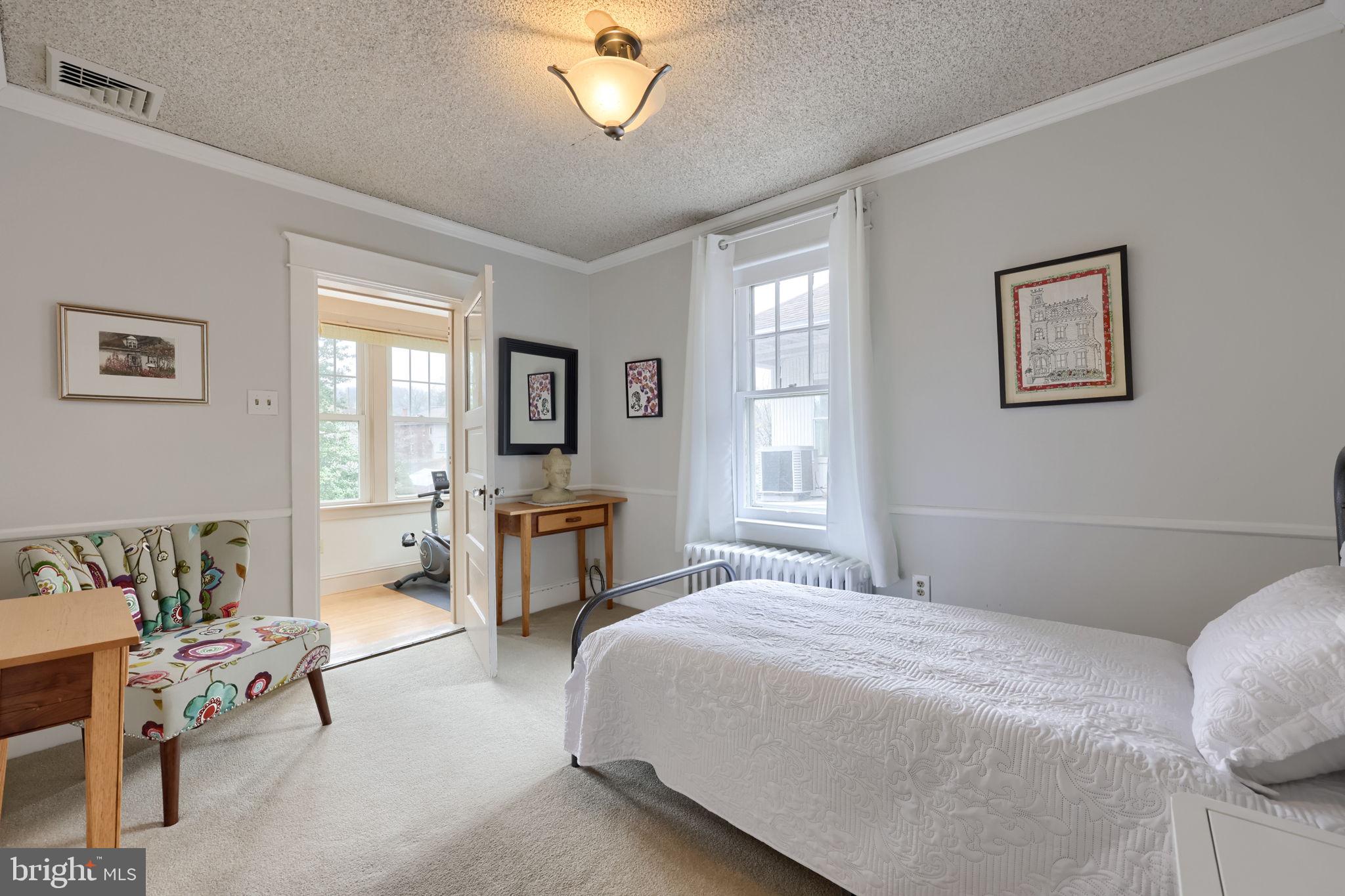 1013 Locust Street Columbia, PA 17512 - Photo 36 of 47 a bedroom with a bed and a chandelier