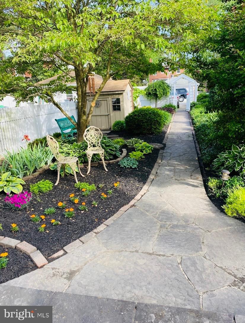 1013 Locust Street Columbia, PA 17512 - Photo 10 of 47 a front view of a house with lots of flowers and trees