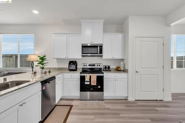 a kitchen with a sink stove and cabinets