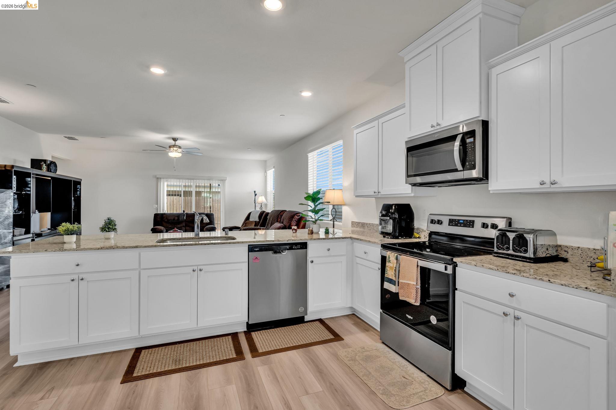 2087 Stars Drive Rio Vista, CA 94571 - Photo 51 of 51 a kitchen with sink a microwave and cabinets