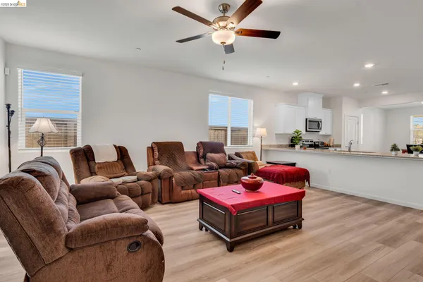 a living room with furniture flat screen tv and wooden floor