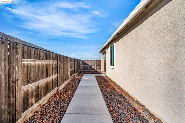 a backyard of a house with wooden fence