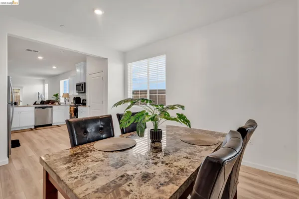 a view of a kitchen and dining table with furniture