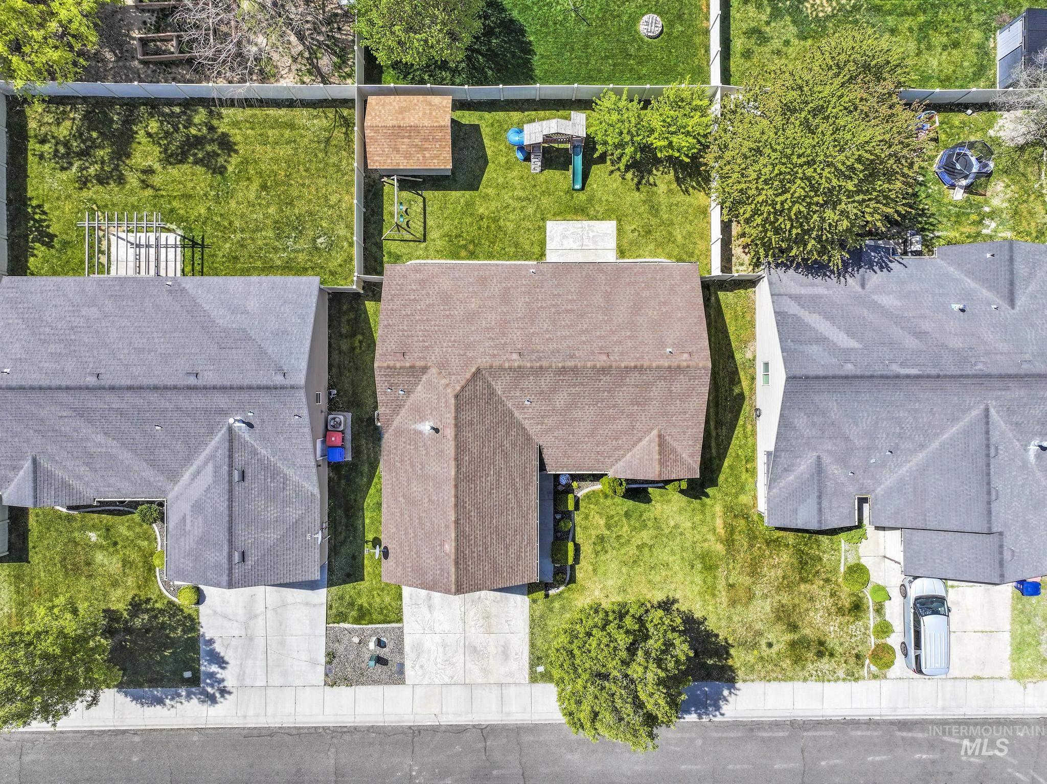 446 Noble Street Twin Falls, ID 83301 - Photo 34 of 42 Expansive property featuring a brown shingled roof, a manicured lawn, an established tree, and a concrete driveway